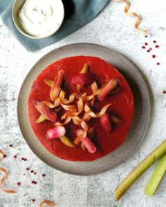 No bake rhubarb and Yoghurt tart seen from overhead, with poached rhubarb segments and candied rhubarb twirls