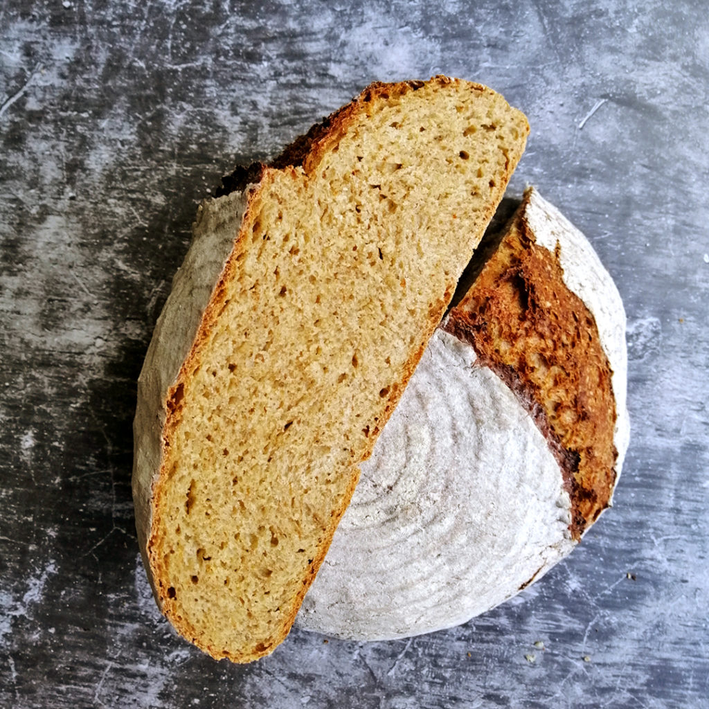 Five-grain no-knead cob cut in half, showing a tight and evenly baked crumb