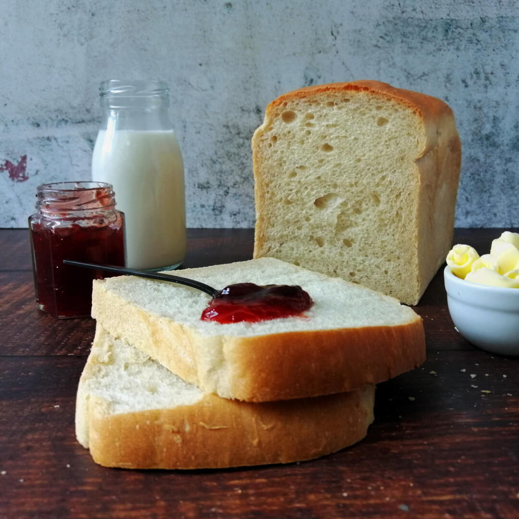 Flurry sandwich bread loaf with sliced of bread in front and some jam spooned on top